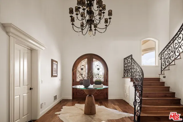 a living room with furniture a fireplace and a large window