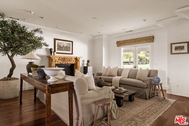 a living room with furniture a fireplace and a large window