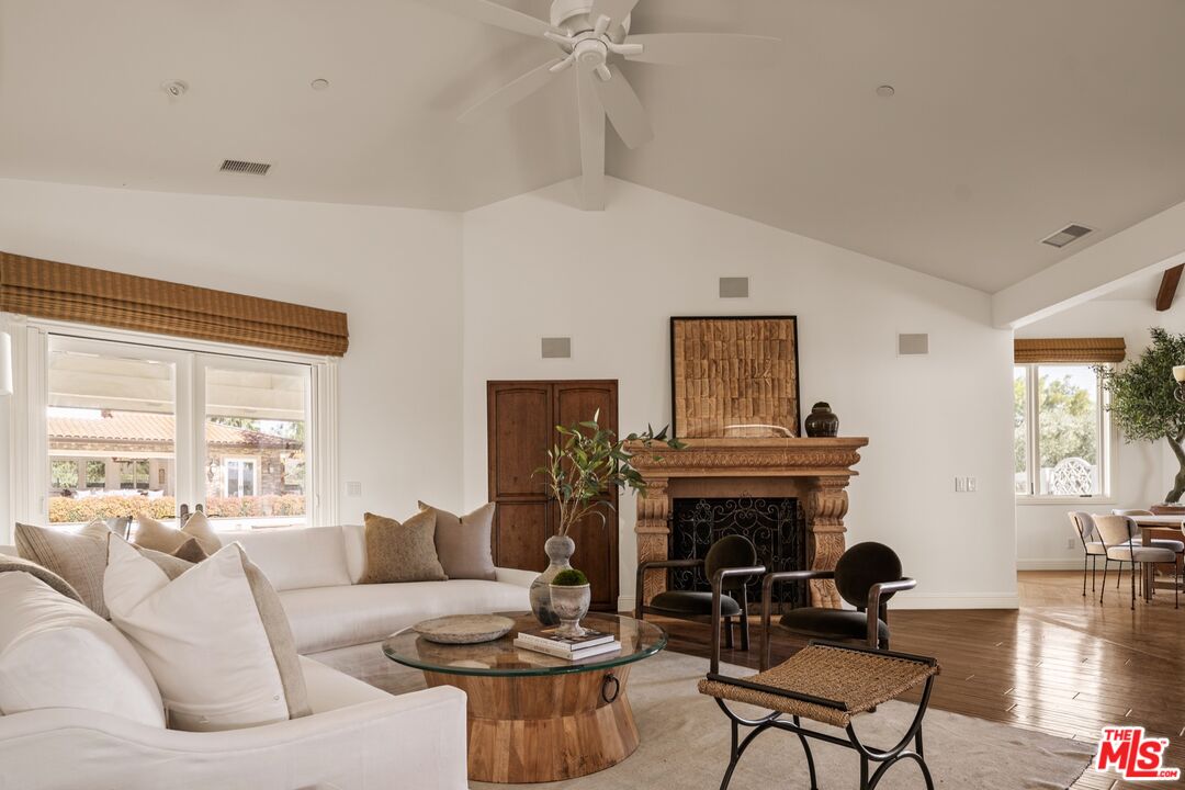 2370 North Refugio Road Santa Ynez, CA 93460 - Photo 10 of 66 a living room with furniture a fireplace and a large window