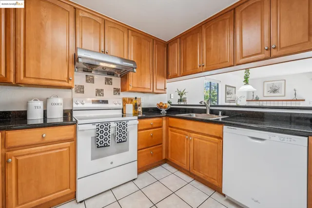 a kitchen with a stove and a refrigerator