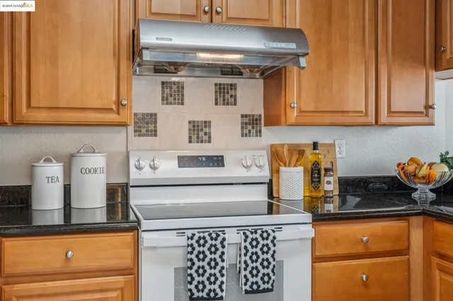 a kitchen with stainless steel appliances a refrigerator and cabinets