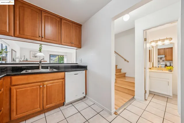 a kitchen with a sink a counter and cabinets