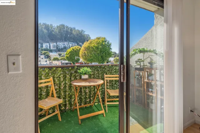 a view of living room filled with furniture and a potted plant