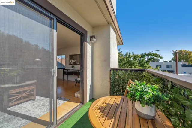 a living room with a bed and a night stand