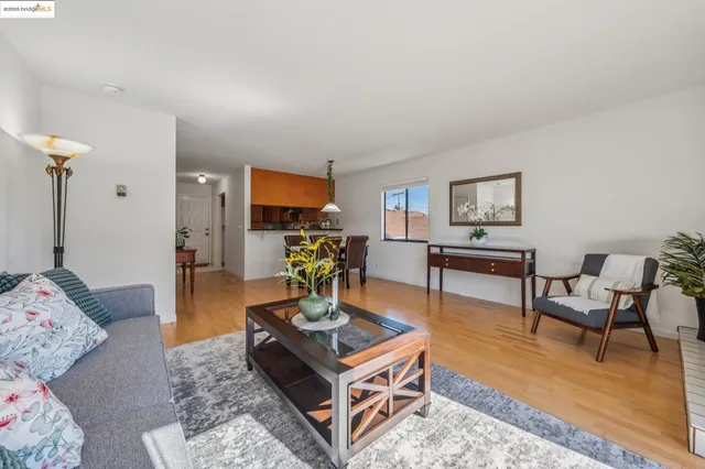 a dining room with furniture a chandelier and wooden floor