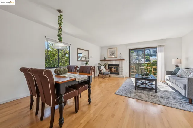 a dining room with furniture a fireplace and wooden floor