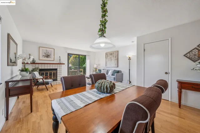 a dining room with furniture a rug and wooden floor