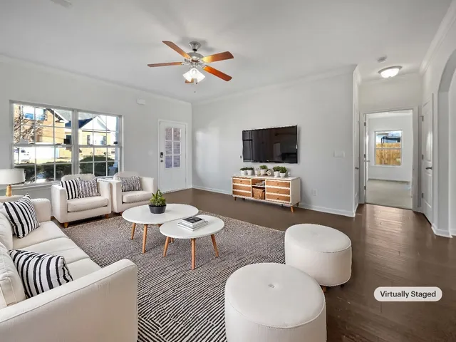 a living room with furniture a rug and a flat screen tv
