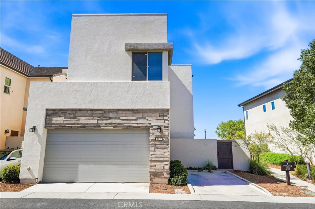 182 Scale Irvine, CA 92618 - Photo 47 of 61 Clean stucco lines, stacked stone accent, a two car garage, and a gated side yard entry. The rear elevation is as considered as the front.