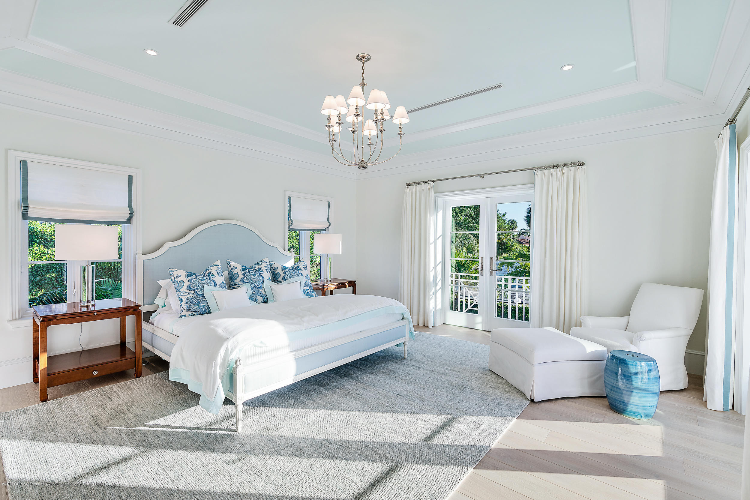 140 Kings Road Palm Beach, FL 33480 - Photo 22 of 42 a bedroom with a large bed and a chandelier