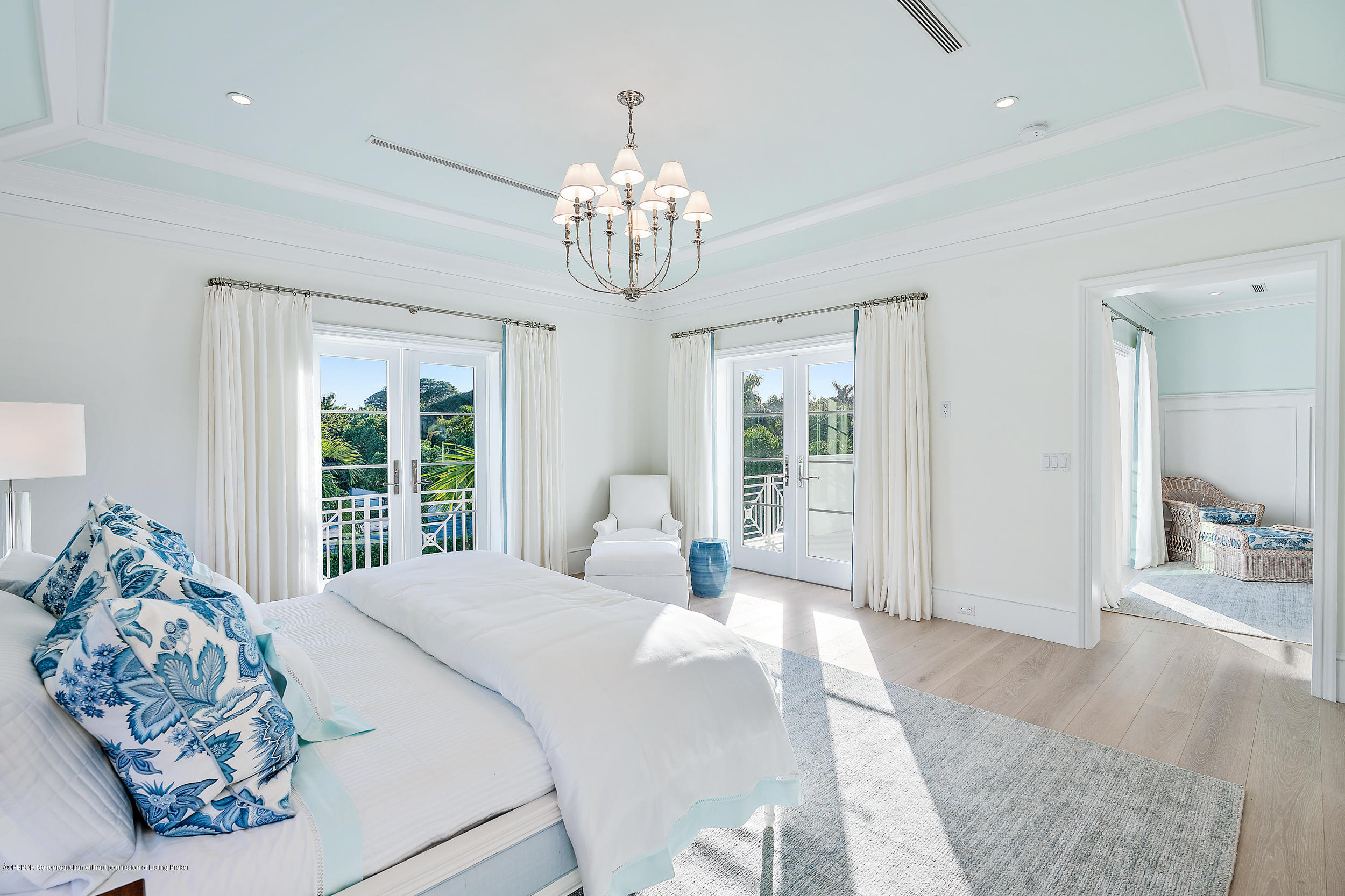 140 Kings Road Palm Beach, FL 33480 - Photo 24 of 42 a bedroom with a large bed and a chandelier