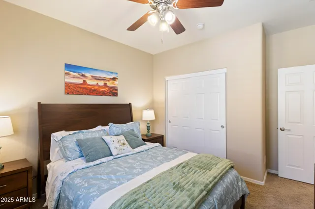 a bedroom with bed and a chandelier