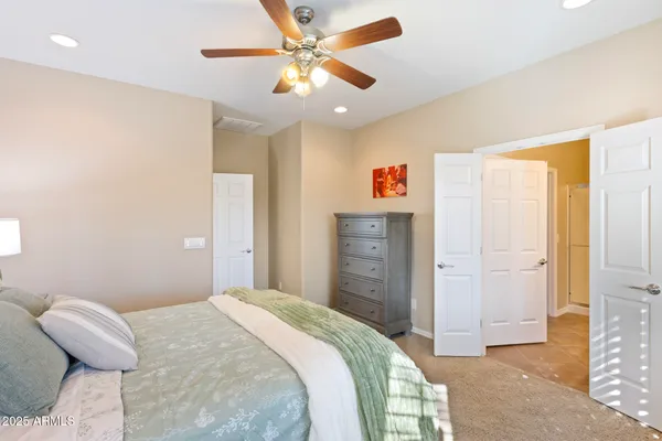 a bedroom with a bed and a chandelier