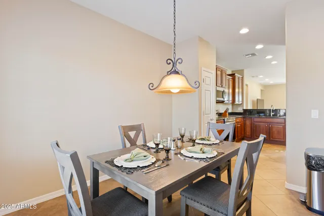 a dining room with a wooden table and chairs