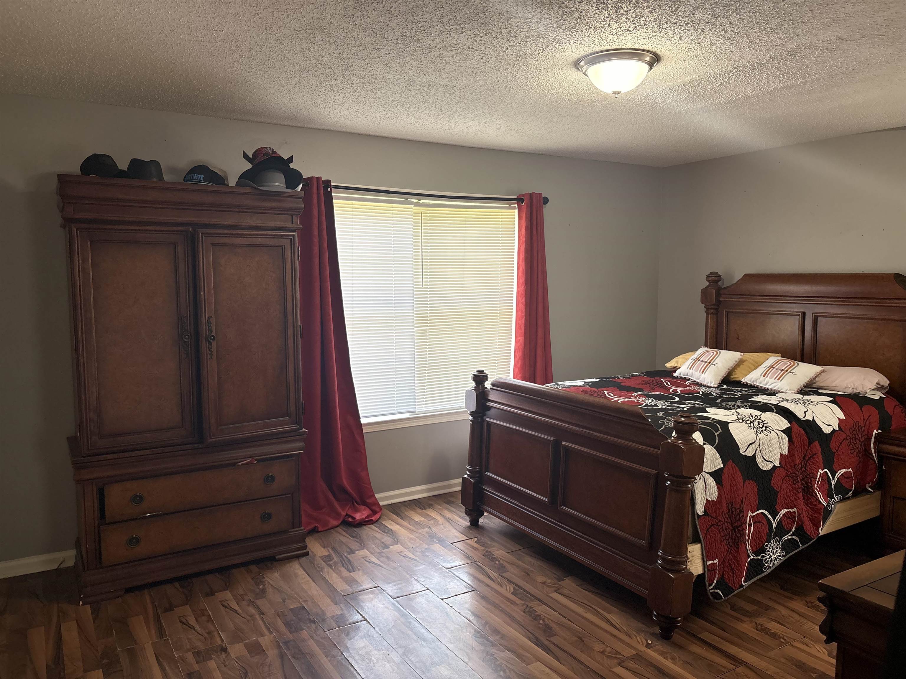 4009 Tessland Road Memphis, TN 38128 - Photo 10 of 16 Room featuring wood-finish flooring, a window with horizontal blinds, and a flush mount ceiling light fixture