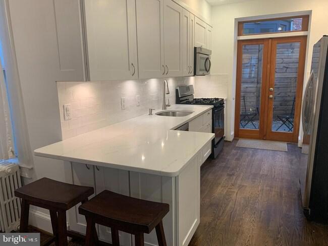 612 C Street Southeast Washington, DC 20003 - Photo 4 of 19 Modern kitchen with natural light and charm.