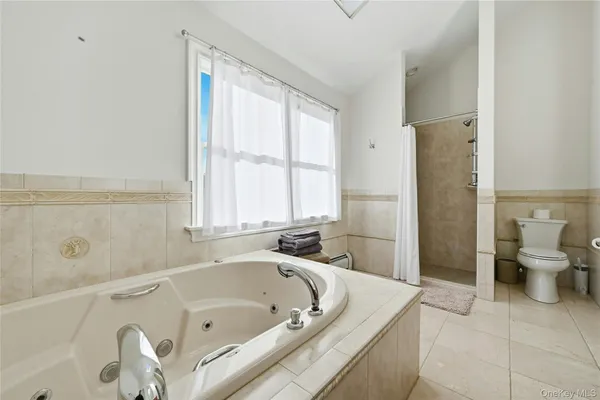 a bathroom with a tub a toilet and a sink