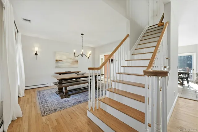 a view of a hallway with entryway wooden floor and windows