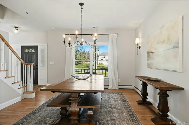 a view of a dining room with furniture window and wooden floor