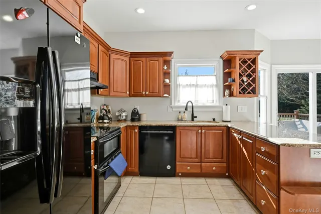 a kitchen with stainless steel appliances granite countertop a refrigerator and a sink