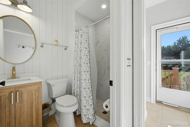 a bathroom with a toilet a sink and a mirror