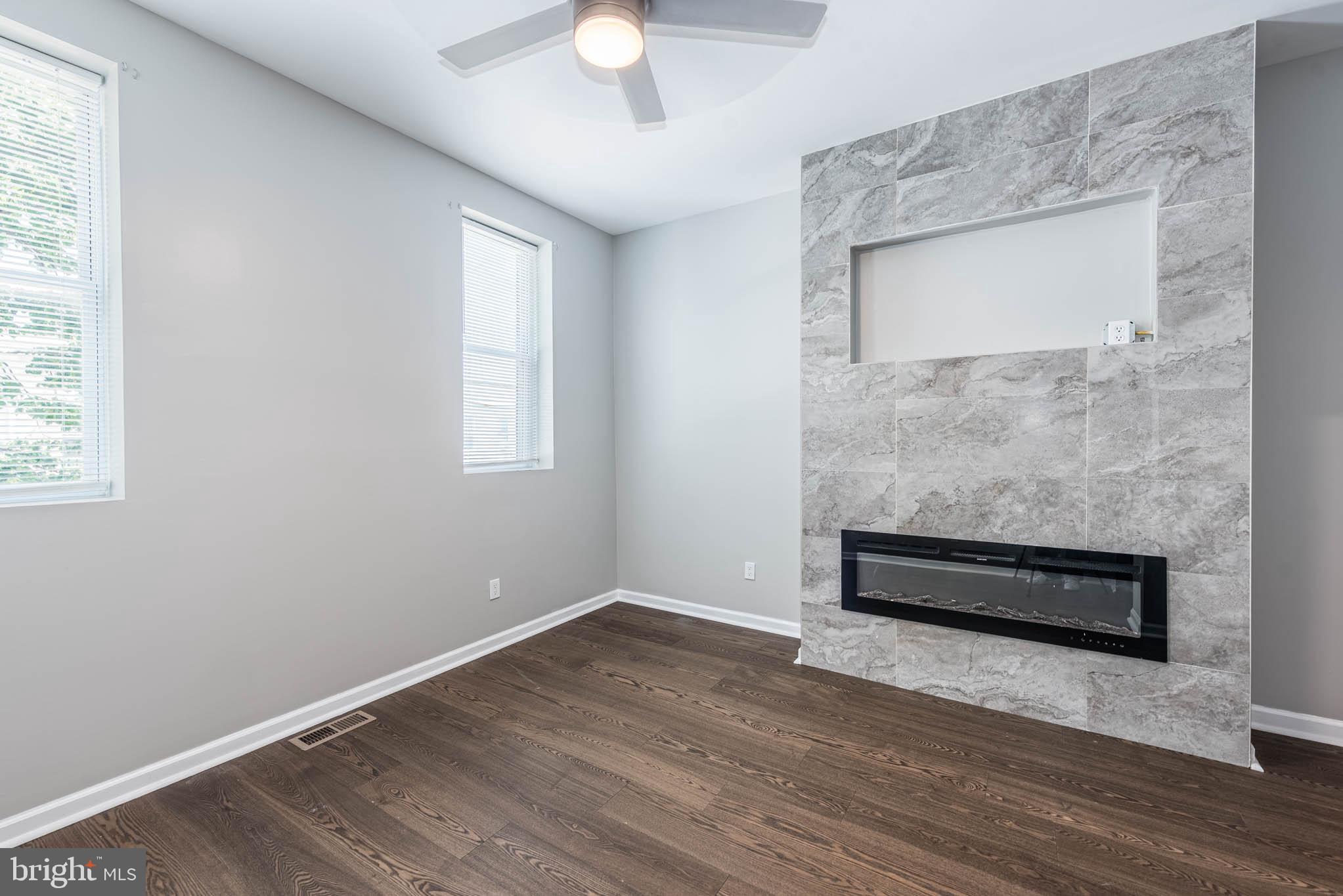 1715 East Oliver Street Baltimore, MD 21213 - Photo 12 of 30 an empty room with wooden floor and windows