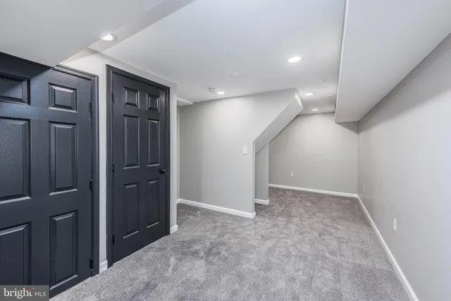 an empty room with closet and wooden floor