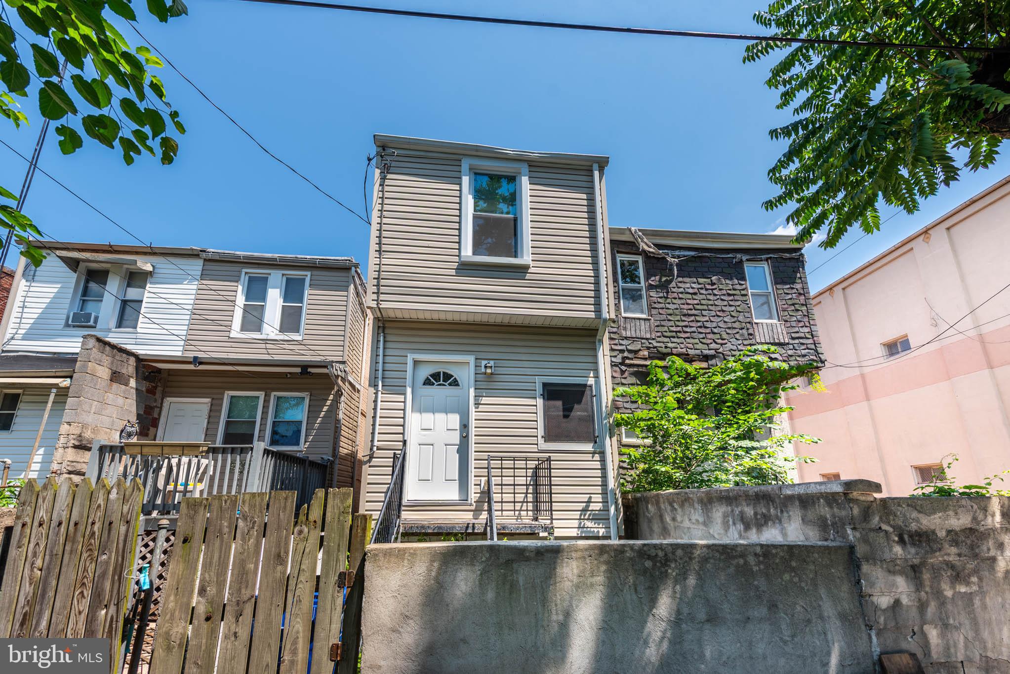 1715 East Oliver Street Baltimore, MD 21213 - Photo 28 of 30 a front view of a house with a yard
