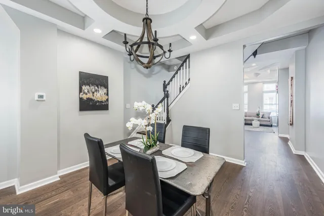 a view of a dining room with furniture wooden floor and chandelier