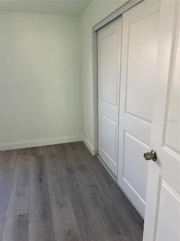 a view of a room with wooden floor and closet