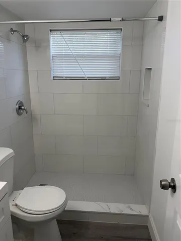 a bathroom with a shower and a toilet