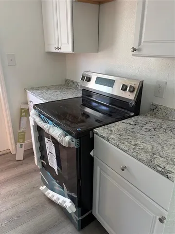 a stove top oven sitting inside of a kitchen