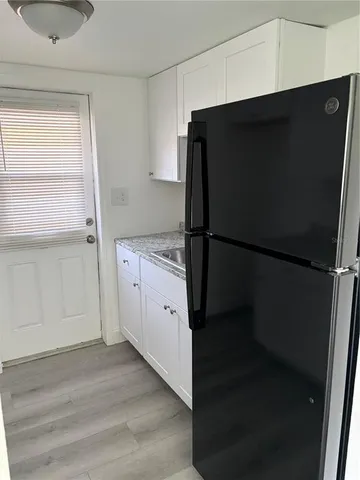 a kitchen with a refrigerator and a sink