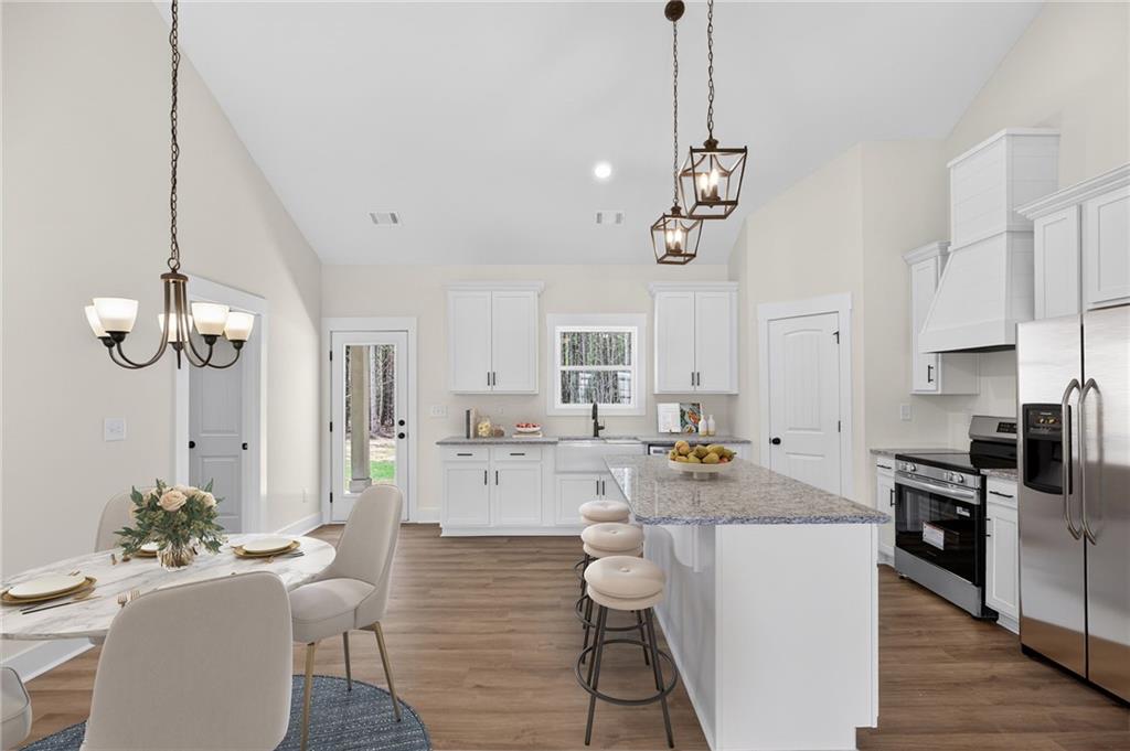 3512-2 Vinson Mountain Road Rockmart, GA 30153 - Photo 11 of 59 a room with stainless steel appliances kitchen island granite countertop a stove a sink a dining table and chairs with wooden floor