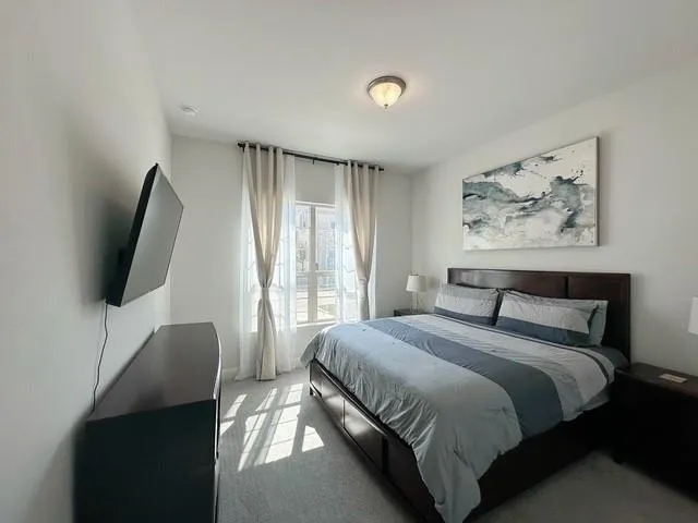 a bedroom with a bed and a flat screen tv