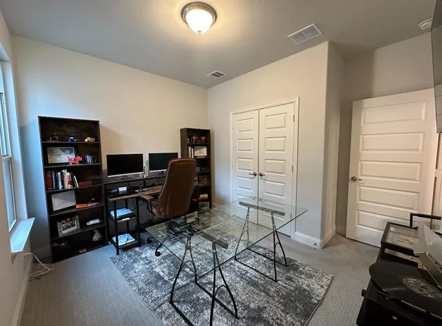 a view of a workspace with furniture