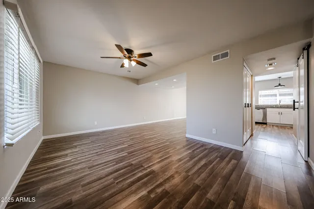wooden floor in an empty room with a window