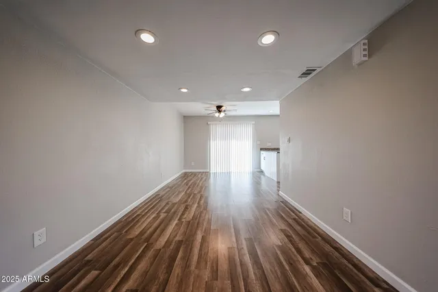 a view of hallway with wooden floor