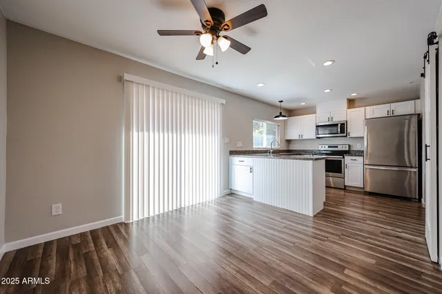 a kitchen with stainless steel appliances a refrigerator sink and cabinets