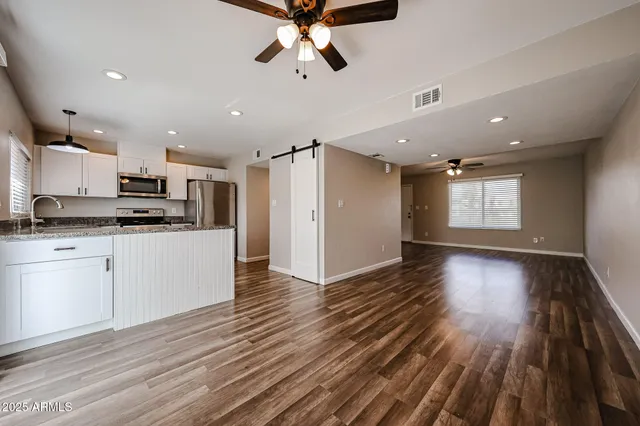 a view of kitchen and closet with wooden floor