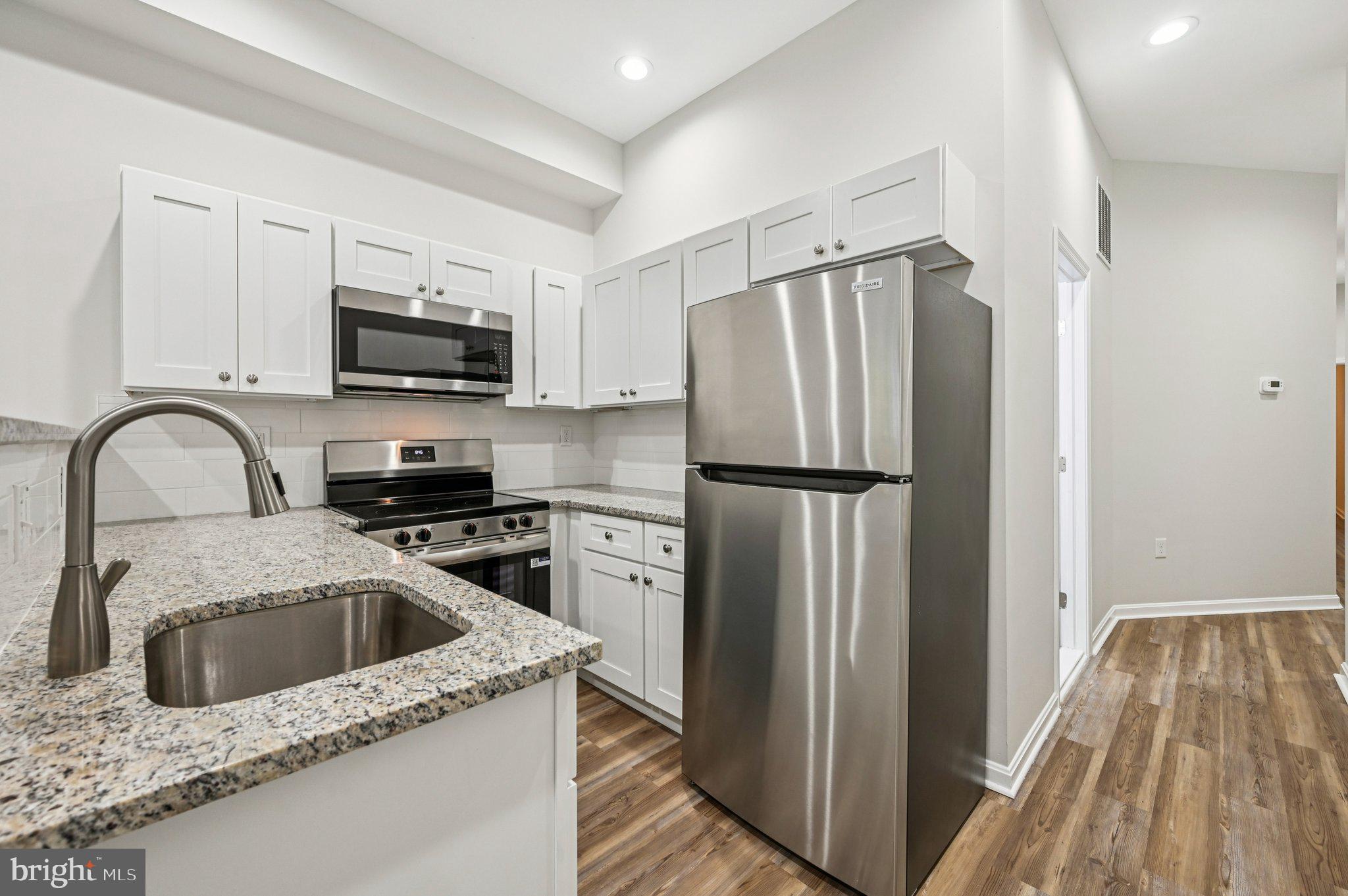 750 Reservoir Street, Unit A Baltimore, MD 21217 - Photo 12 of 23 a kitchen with a refrigerator sink and microwave
