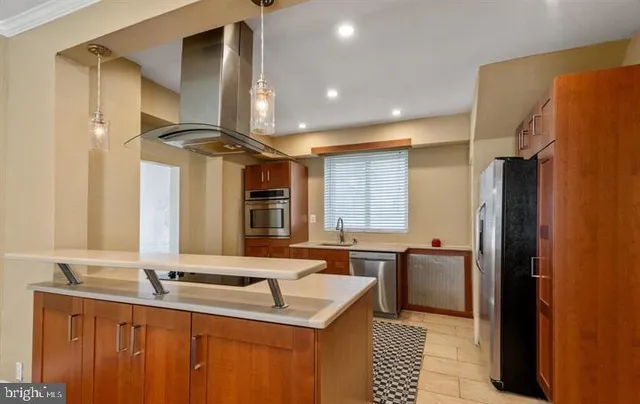 a kitchen with a sink a refrigerator and outdoor space