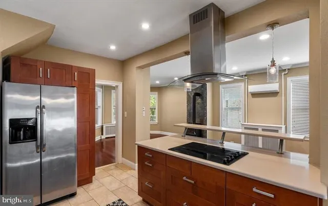 a kitchen with stainless steel appliances granite countertop a sink and a refrigerator