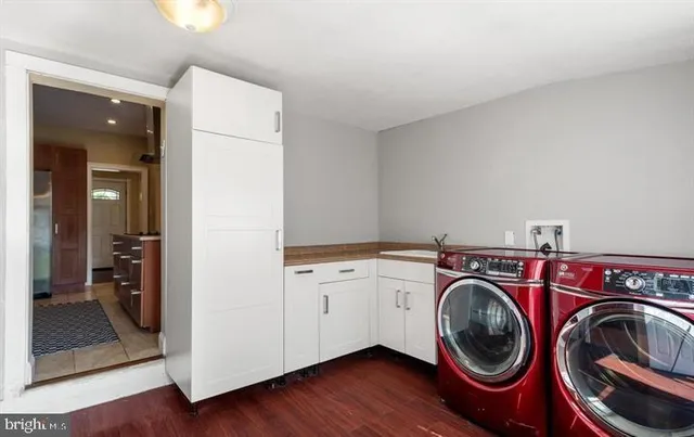 a utility room with sink dryer and washer