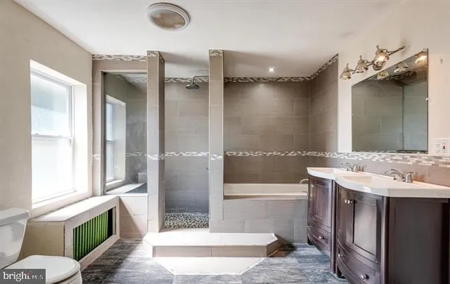 a bathroom with a tub shower and sink