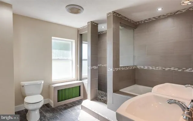 a bathroom with a sink toilet and shower