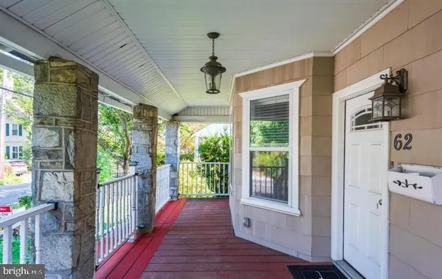a view of a porch with wooden floor and windows