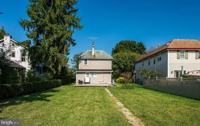 a yellow house with trees in front of it