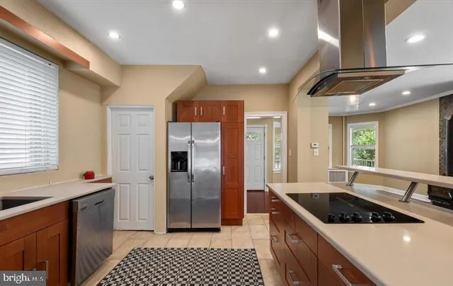 a kitchen with stainless steel appliances granite countertop a sink a stove a refrigerator and a cabinets