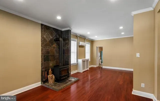 a view of an empty room with wooden floor